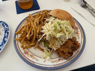 Fried chicken sandwich with fries and slaw at Le Mu Eats
