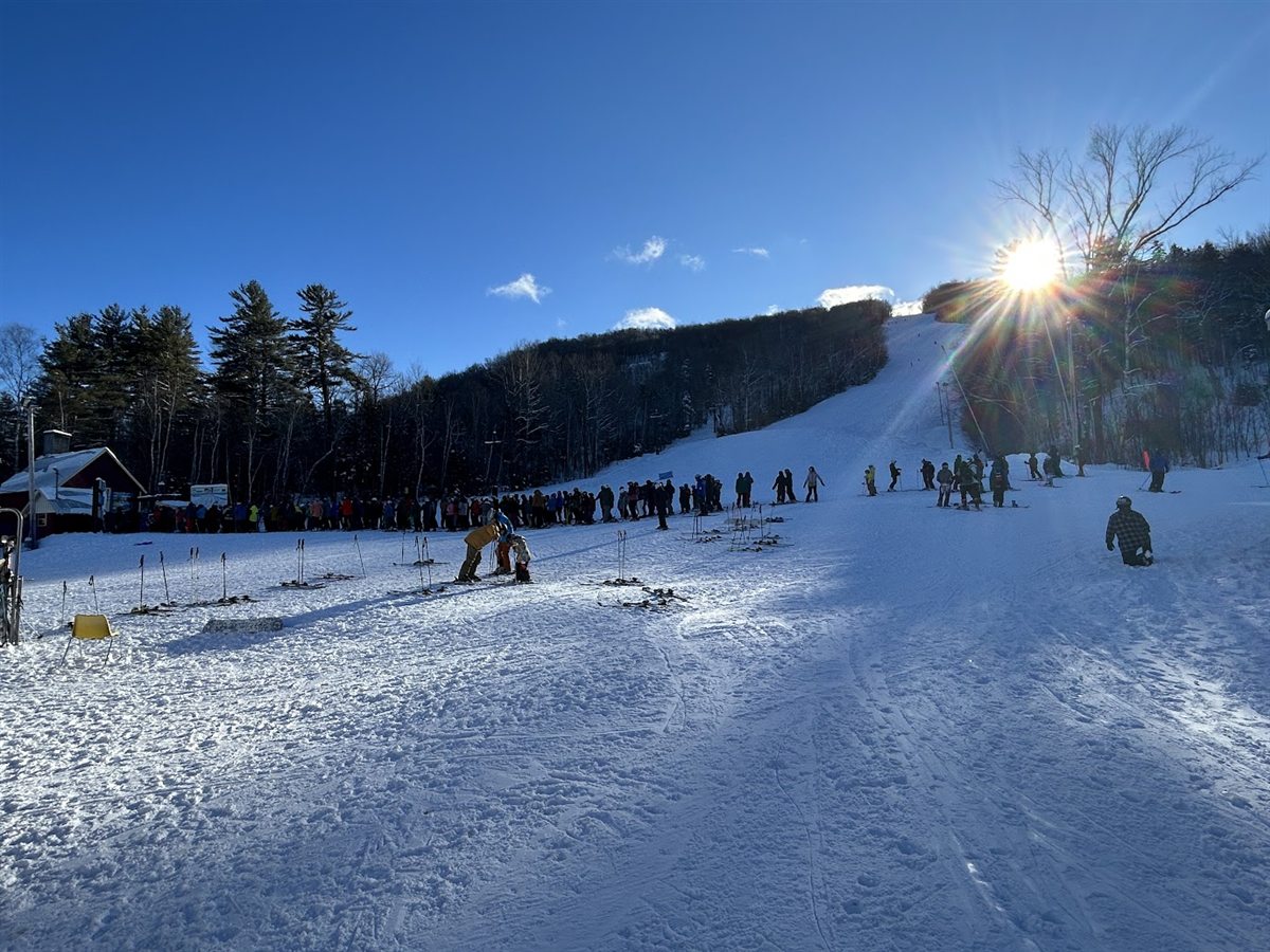 Skiers gathered beneath a bright winter sun at Mt. Abram