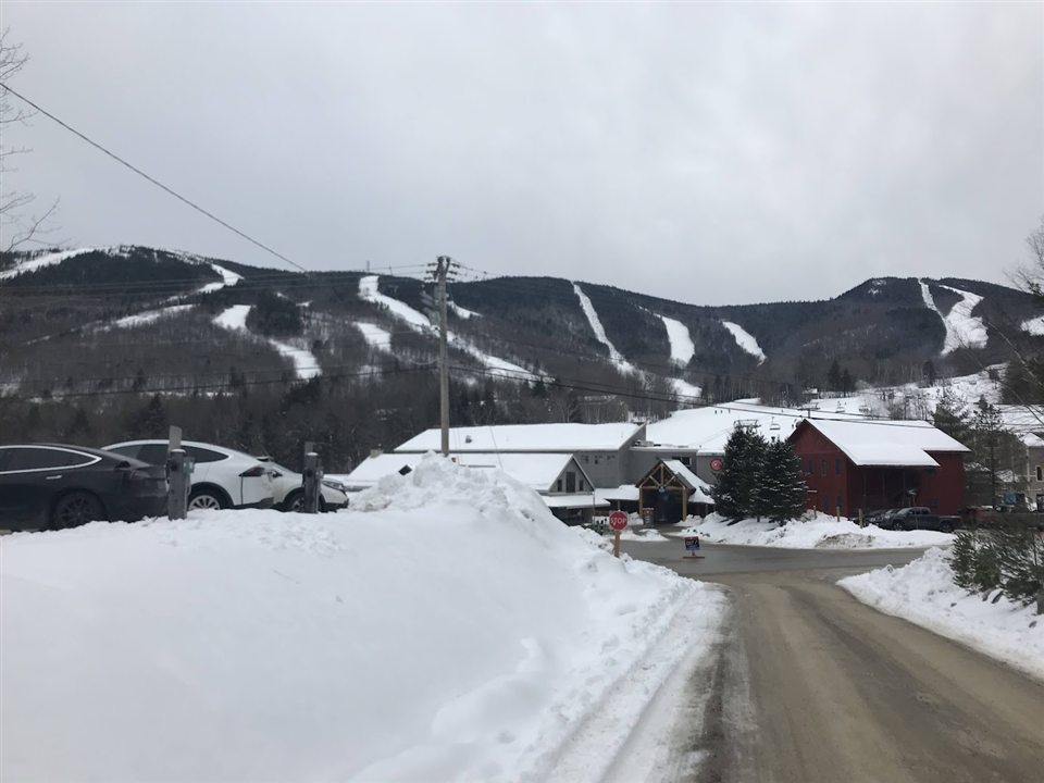 Sunday River ski trails seen across a snowy access road